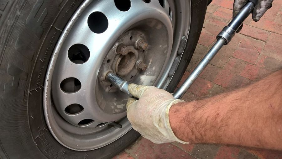 person fixing a car tire