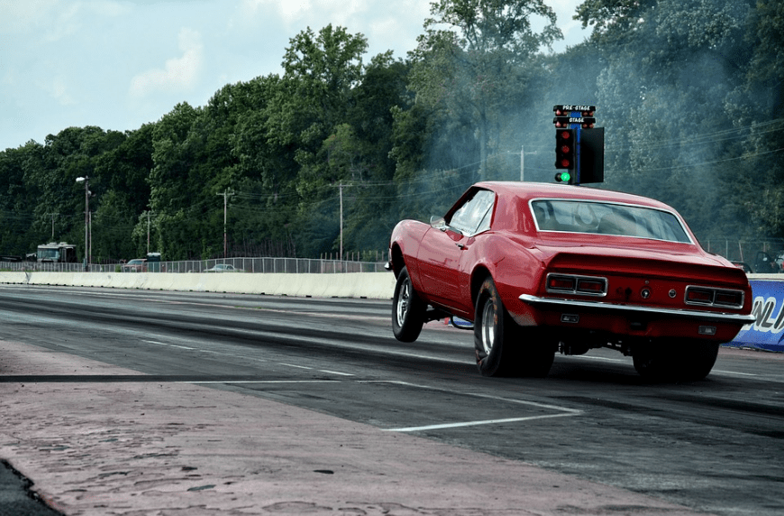 A red Camaro in a drag race