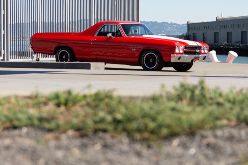 A red El Camino parked at the San Francisco Piers.
