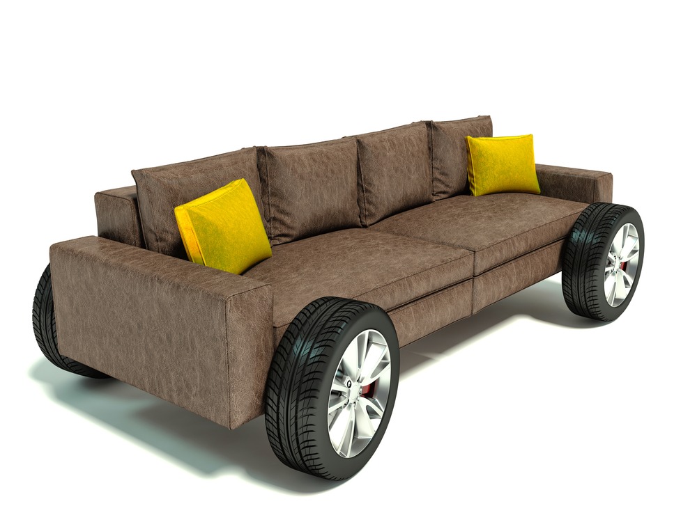 The concept of moving to a new home. Sofa on wheels