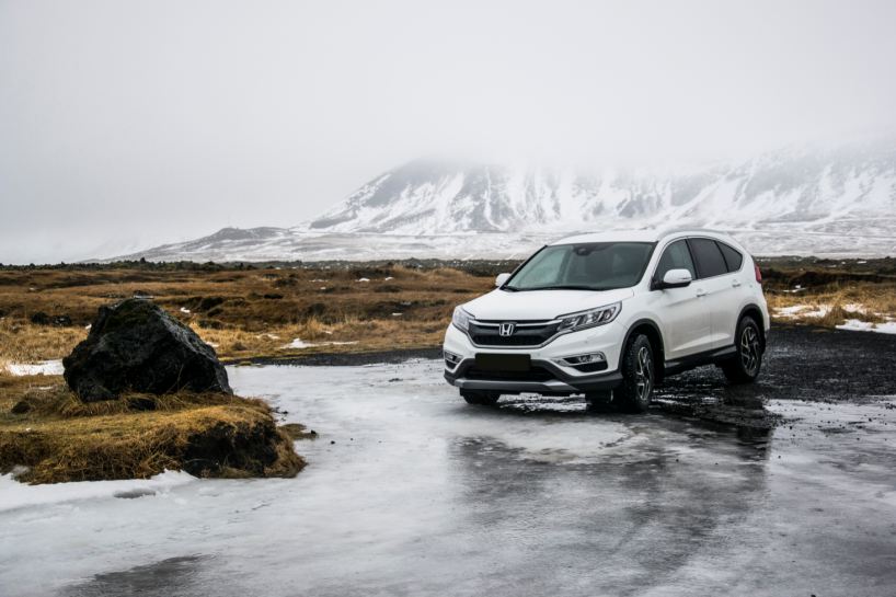 White Honda SUV in a mountainous surrounding.