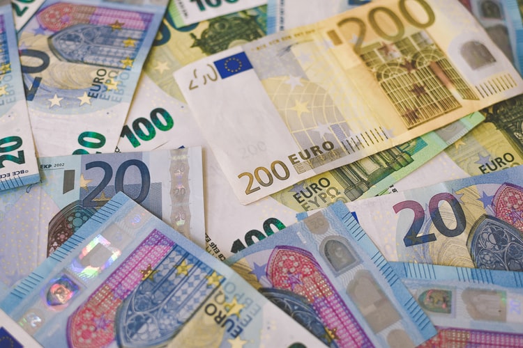 A pile of Euro (EUR) banknotes that include 20, 100, and 200 notes.