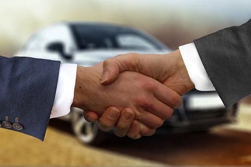 Buyer and seller making a deal of car