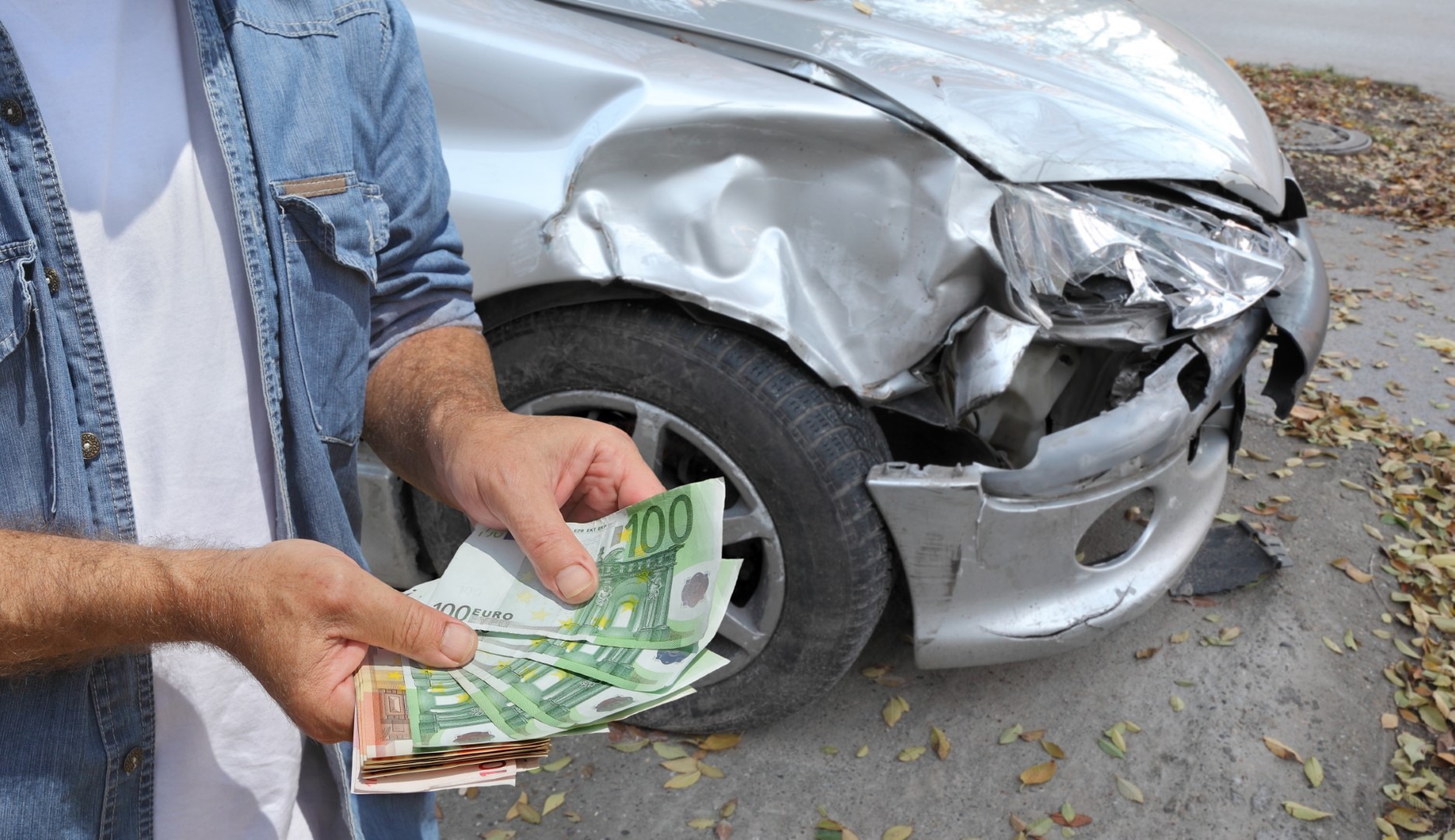 Person with money and damaged car