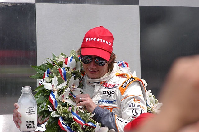 2011 500 champion Dan Wheldon, with laurel wreath and drinks milk as part of the tradition