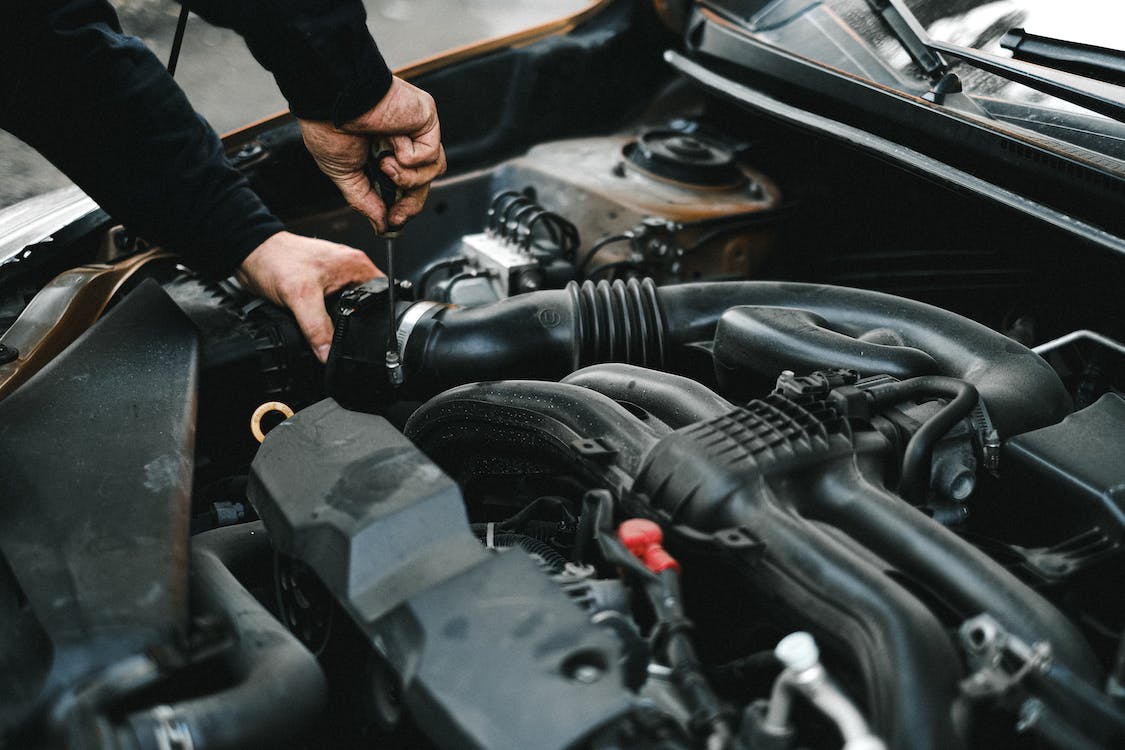 a man checking the engine of a car
