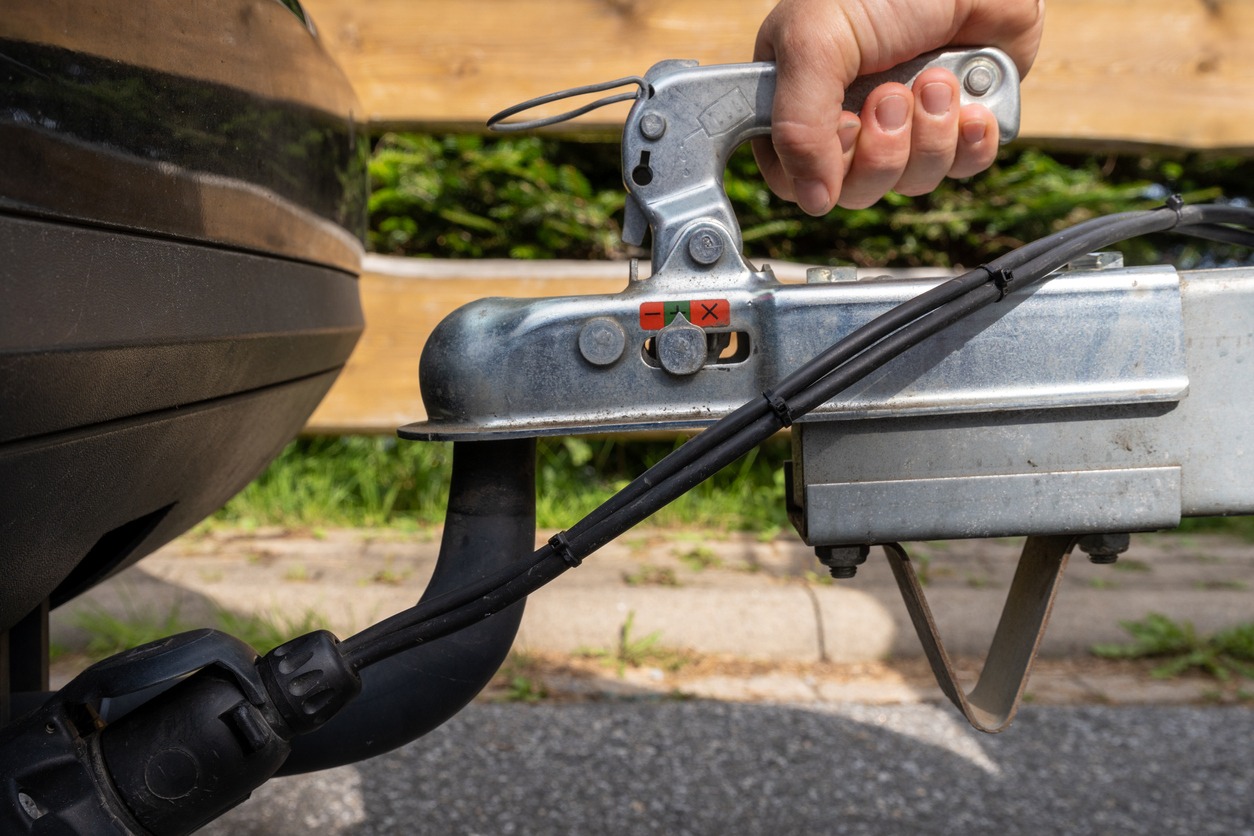 hand-gsasping-the-fixation-of-a-trailer-closed-hitch-lock