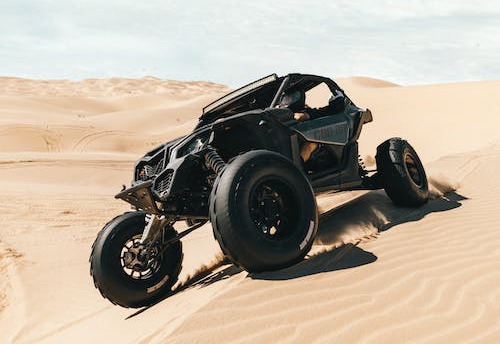 a black dune buggy in the desert