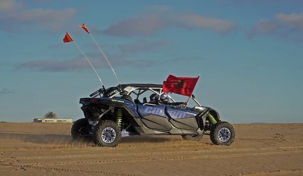 blue dune buggy on desert land