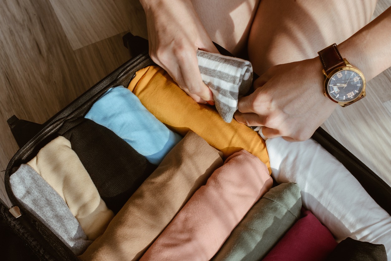 packing clothes in a small suitcase