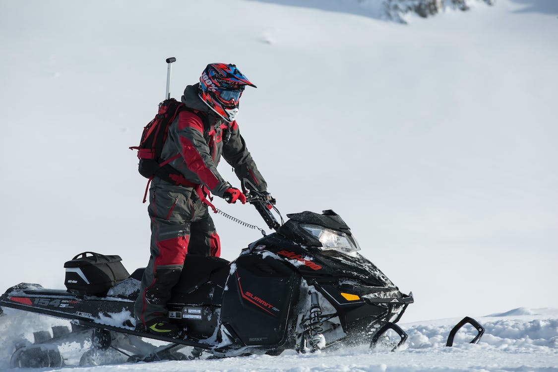 person riding on a snowmobile