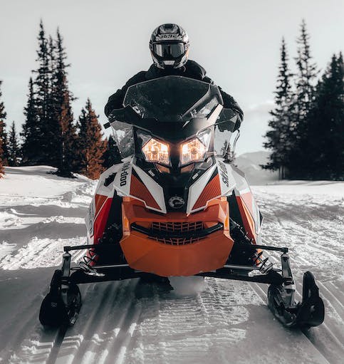 photo of a person riding a snowmobile