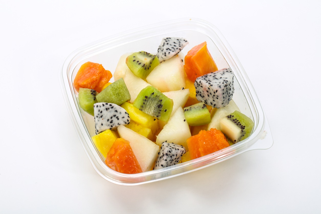 sliced fruits in a plastic container
