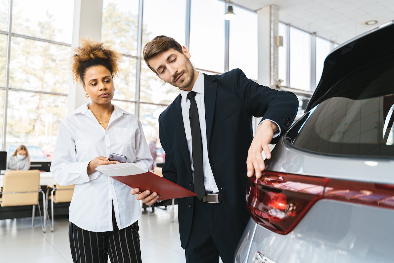 woman buying a car from the dealer