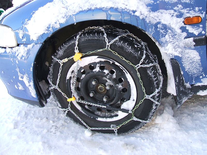 Link-type, diamond pattern snow chains on a front-wheel drive automobile