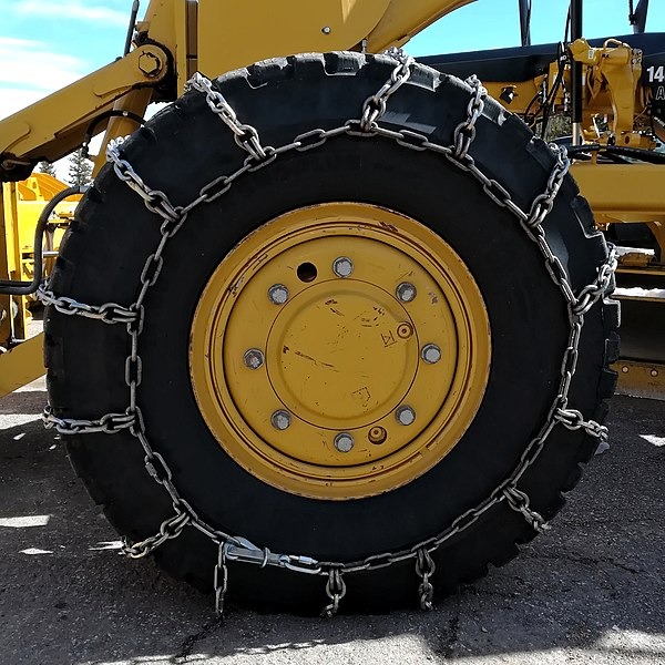 Snow chains at the front wheel of a grader at the Pikes Peak Highway
