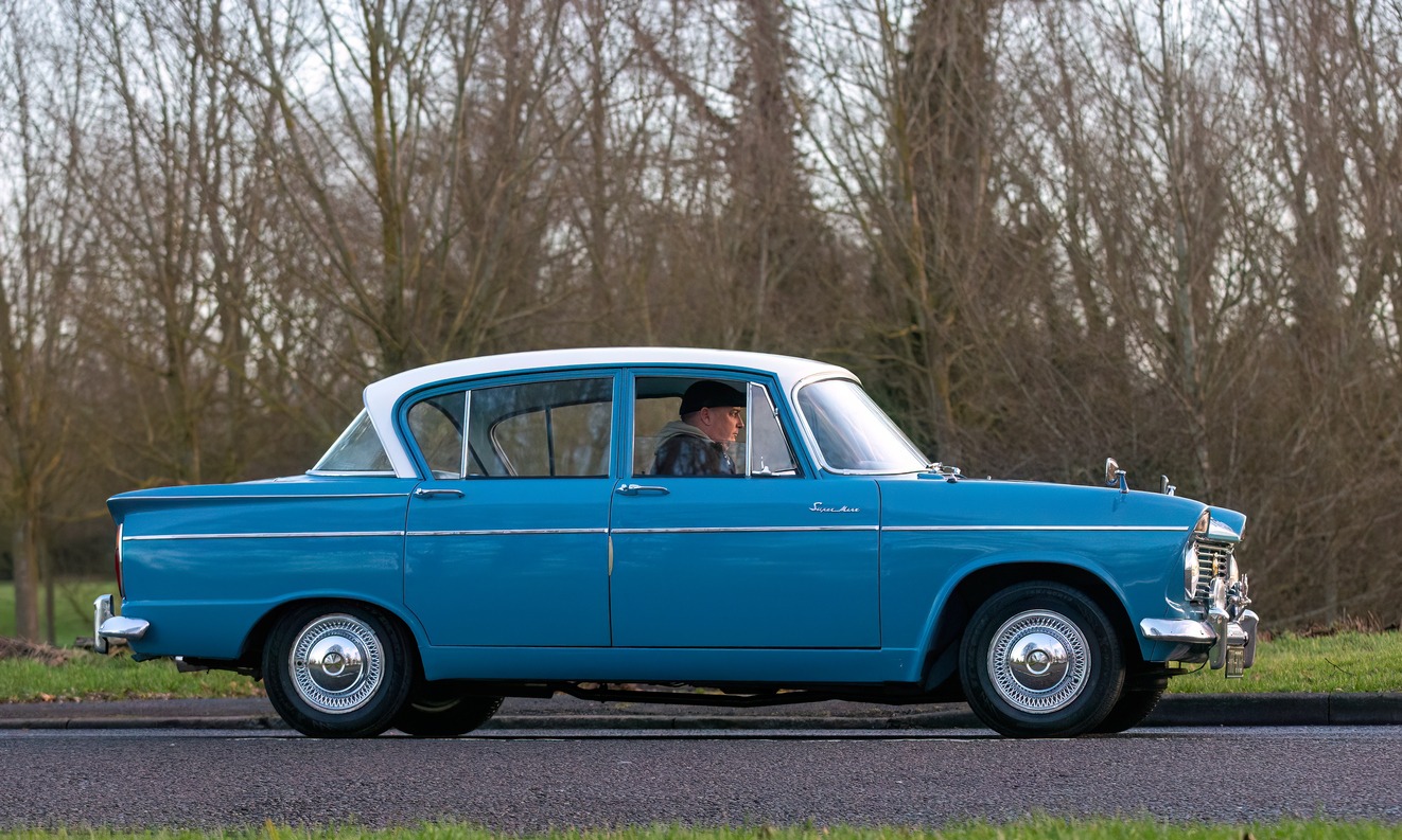 1964 blue Hillman Super Minx car being driven by a man