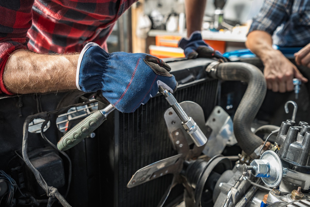 a mechanic restoring a classic car engine