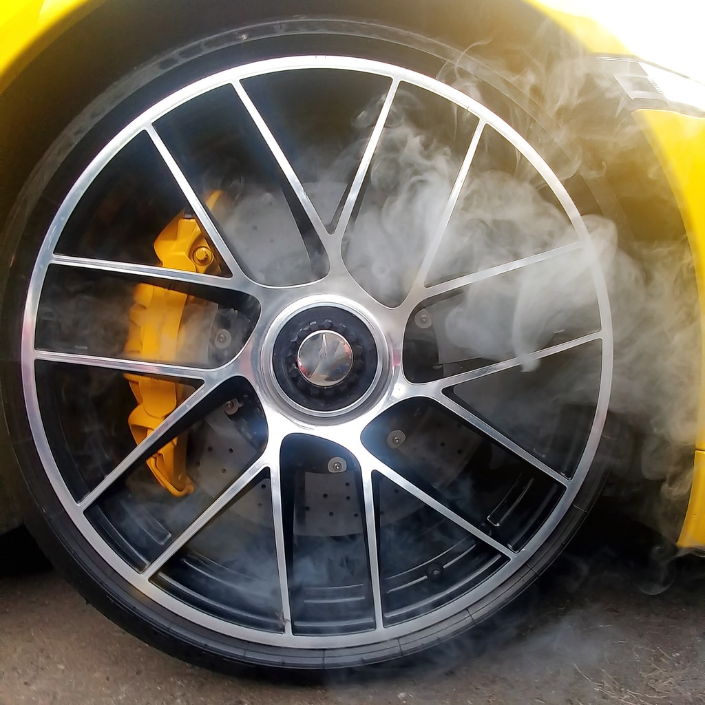 yellow car with alloy wheels and carbon ceramic brakes