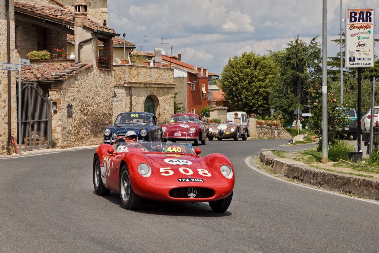 Vintage racing car Maserati 200 SI (1957) runs in Tuscan village in classic car race Mille Miglia