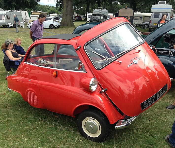 a BMW Isetta parked on the grass
