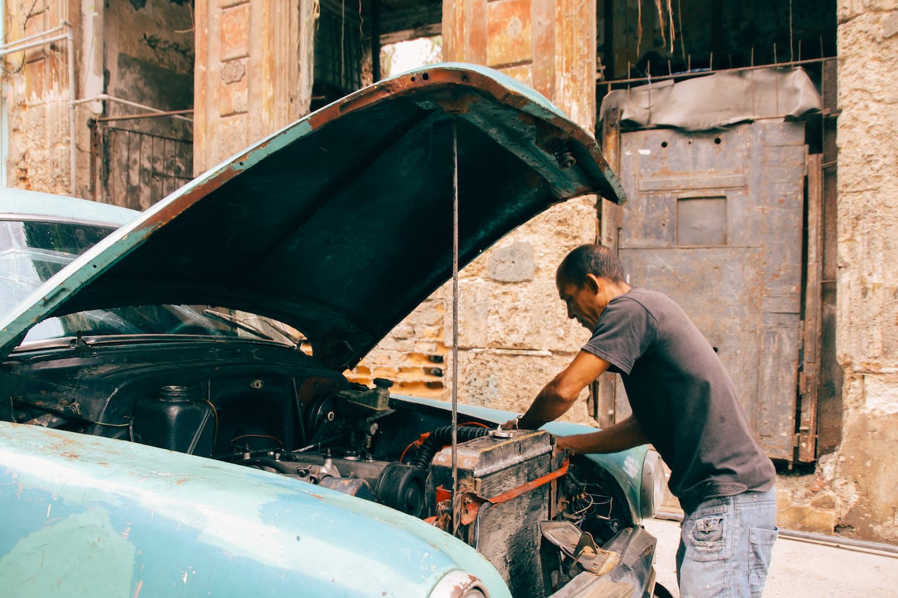 a man fixing an old car