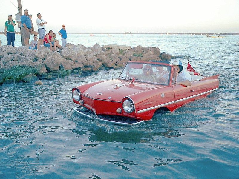 a red Amphicar on water