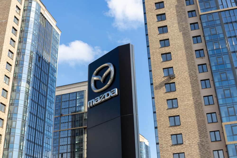 Mazda brand logo on against skyscrapers